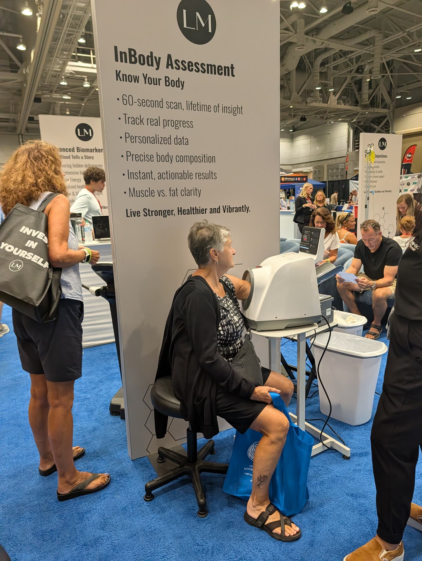 A visitor getting an InBody body composition scan at the LifeMed Institute booth