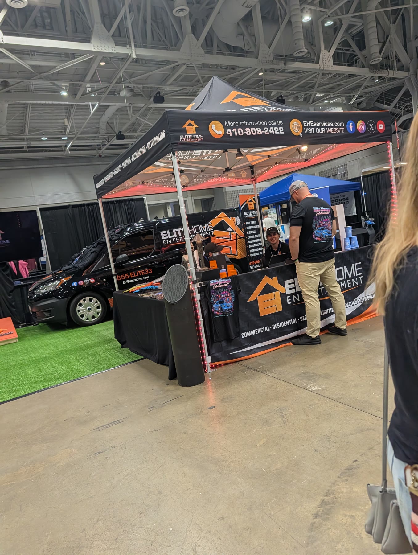 Elite Home Entertainment booth with branded tent and service van at E-Volution Expo