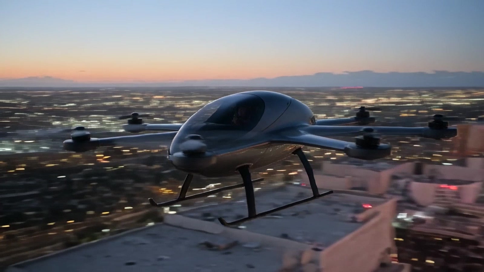 Illustration of a small eight-rotor personal electric aircraft lifting off over the Las Vegas Strip at dusk