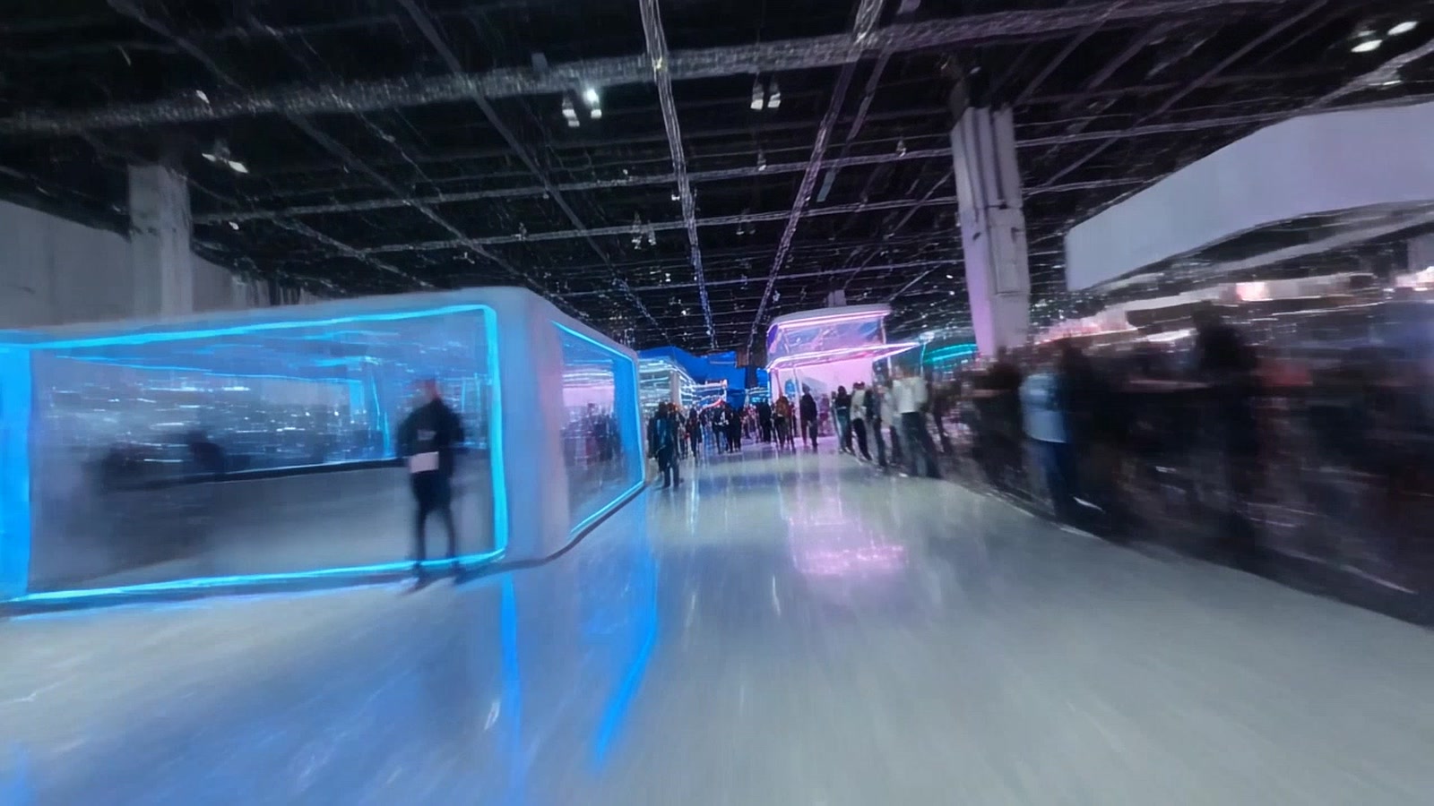 Illustration of a packed futuristic technology convention hall with giant LED walls and crowds