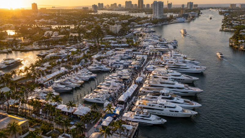 Aerial view at golden hour of hundreds of white motor yachts moored in rows along floating docks on the Fort Lauderdale Intracoastal Waterway