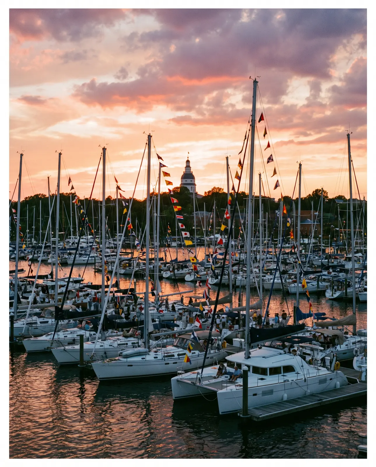 Sailboat masts and signal flags at sunset in Annapolis harbor