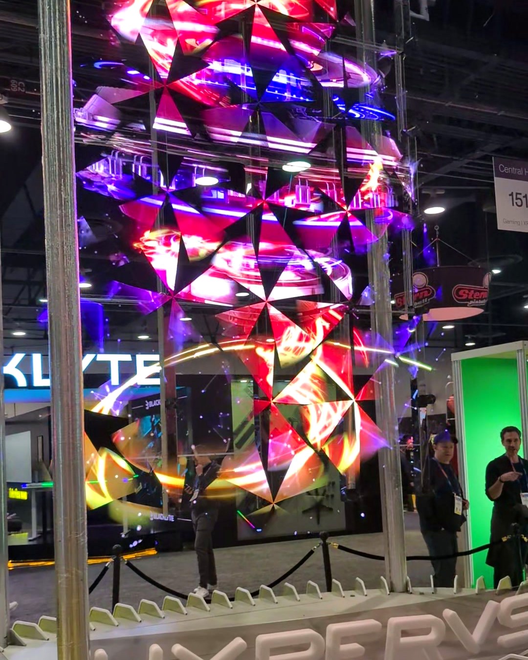Tall HYPERVSN SmartV Wall showing a spinning 3D light sculpture above a curved base at CES 2025