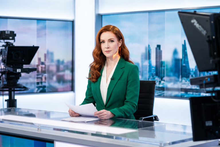 Kitty Jackson at a bright TV news desk