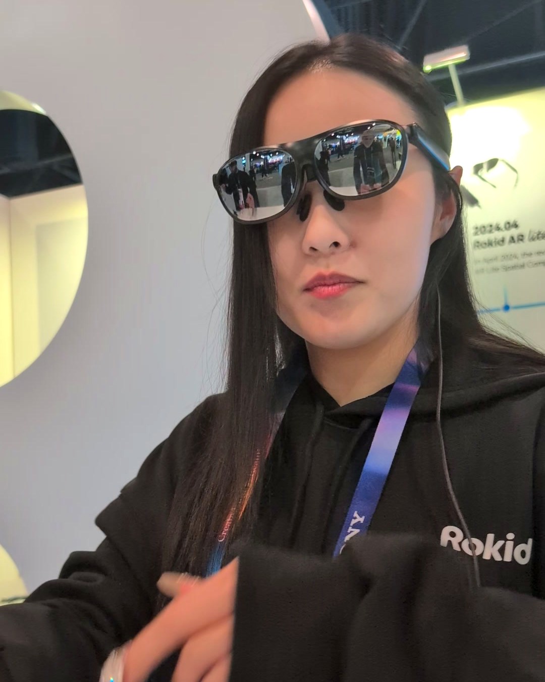 Rokid staff member wearing tethered AR glasses during a demo at CES 2025